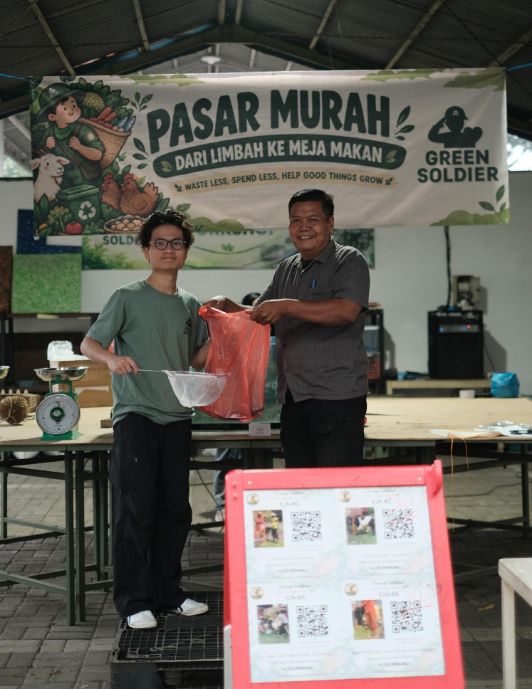 A buyer at Green Soldier's Pasar Murah event, where proceeds from agricultural product sales help fund the initiative's environmental programs.(Source: Green Soldier market activity documentation)